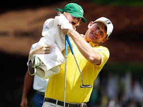 Brandt Snedeker holds his daughter Lily during the Par 3 contest at the Masters golf tournament Wednesday, April 8, 2015, in Augusta, Ga. (AP Photo/Chris Carlson)
