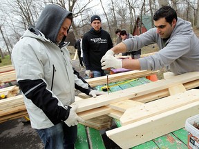 Chad Koschuck and Julien Obeid (right) build picnic tables at Gesstwood Camp in near Essex on Monday, April 27, 2015. Close to 50 volunteers from FCA Canada took time off from their regular jobs to build and paint at the retreat centre. The volunteers were joined by the United Way and Centraide Windsor-Essex County.                (TYLER BROWNBRIDGE/The Windsor Star)