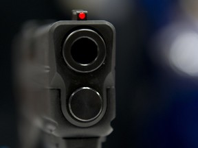 Looking down the barrel of a semi-automatic pistol on display at a NRA meeting in Indiana in April 2014. (Karen Bleier / AFP / Getty Images)