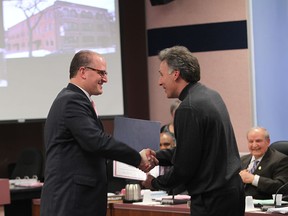 Windsor mayor Drew Dilkens, left, awards Mike Brkovich with a Heritage award on April 7, 2015 in Windsor, Ontario. (JASON KRYK/The Windsor Star)