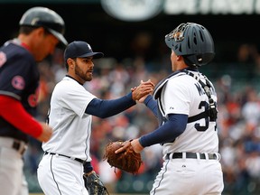 Detroit Tigers pitcher Joakim Soria, middle celebrates the final out with catcher James McCann against the Cleveland Indians in the ninth inning of a baseball game in Detroit, Sunday, April 26, 2015. Detroit won 8-6. (AP Photo/Paul Sancya)