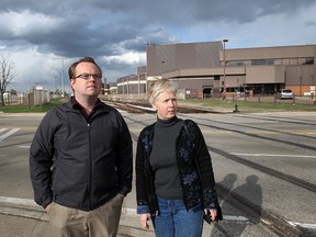 Shane Mitchell and Philippa van Ziegenweidt stand at the old GM plant on Kildare Avenue in Windsor, Ont. in this April 2015 file photo. The site on Walker Road was one of 22 sites considered for the proposed mega hospital.