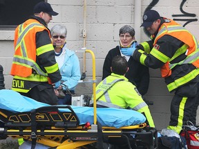 Emergency personnel care for two women involved in an accident on Monday, April 6, 2015, at the intersection of Tecumseh Rd. W. and California Ave. in Windsor, ON. The 3 vehicle crash occurred shortly after noon. Injuries were minor. California Ave. was closed for approximately an hour. (DAN JANISSE/The Windsor Star)