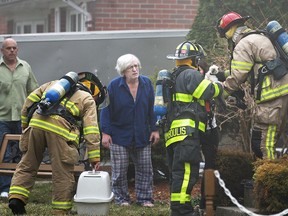 Windsor firefighters bring some pets to their owner at a house fire at 3115 Virginia Park Ave. in south Windsor on April 3, 2015. (Dax Melmer / The Windsor Star)