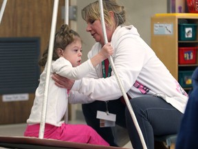 Resource teacher Kathleen Caille works with Hillary Ellis, 5, on Tuesday, April 7, 2015, at the John McGivney Children's Centre in the preschool program at the facility. (DAN JANISSE/The Windsor Star)