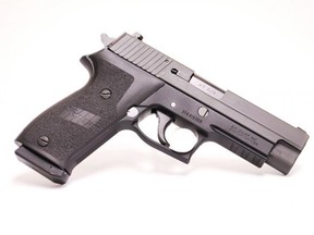A promotional image of a .45 ACP Sig Sauer P220 semi-automatic pistol.