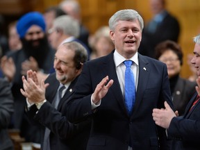 Prime Minister Stephen Harper is appaluded by Conservative MPs as he answers a question during Question Period in the House of Commons in Ottawa on Wednesday, April 1, 2015. (Adrian Wyld/The Canadian Press)