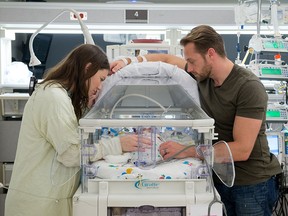 Parents Danielle, left, and Adam Busby spend time with Parker Kate, one of their quintuplets born on April 8, 2015, at The Woman's Hospital of Texas in Houston,. (Courtesy of Charles Falk/The Women's Hospital of Texas)