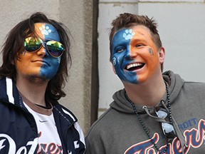 James Boulahanis, 25, left, and Tim Wolak, 26, get painted up as they celebrate Opening Day of the 2015 Detroit Tigers season in downtown Detroit, Monday, April 6, 2015.  (DAX MELMER/The Windsor Star)