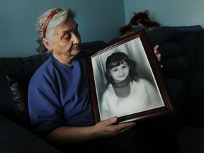 In this file photo, Paula Topic holds a portrait of her daughter Ljubica Topic, who was murdered, at her home in Windsor on Friday, April 17, 2015. Police have released the fact that a tooth was found at the scene of the murder in hopes someone will come forward with new information in the 44 year old case.              (TYLER BROWNBRIDGE/The Windsor Star)