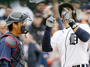 Detroit Tigers' J.D. Martinez looks skyward after his solo home run during the second inning of an opening day baseball game against the Minnesota Twins in Detroit, Monday, April 6, 2015. (AP Photo/Carlos Osorio)