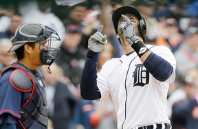 Detroit Tigers' J.D. Martinez looks skyward after his solo home run during the second inning of an opening day baseball game against the Minnesota Twins in Detroit, Monday, April 6, 2015. (AP Photo/Carlos Osorio)