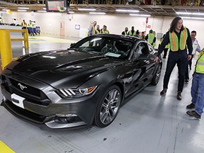 Luke Willson gets his first look at his new Ford Mustang GT as it rolls off the line at the assembly plant in Flat Rock, Michigan on Wednesday, April 1, 2015. Willson, who plays for Seattle Seahawks, got the chance to tour the plant after purchasing the car from Rose City Ford.              (TYLER BROWNBRIDGE/The Windsor Star)