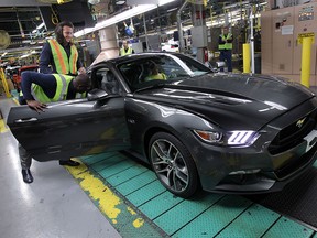 Luke Willson gets his first look at his new Ford Mustang GT as it rolls off the line at the assembly plant in Flat Rock, Mich., on Wednesday, April 1, 2015. Willson, who plays for the Seattle Seahawks, got the chance to tour the plant after purchasing the car from Rose City Ford.              (TYLER BROWNBRIDGE/The Windsor Star)