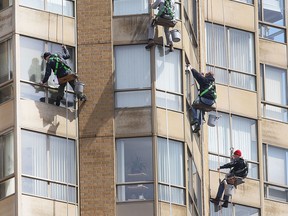 A quartet of window washers had a warm and sunny day to take on a downtown Windsor, ON. high-rise condo building on Goyeau St. on Wednesday, April 15, 2015.   (DAN JANISSE/The Windsor Star)