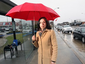 Caroline Grech of CAA South Central Ontario stands at the corner of Tecumseh Road East and Howard Avenue in Windsor on April 9, 2015. Tecumseh Road East is currently leading the area in votes for the title of worst road in the region. (Dan Janisse / The Wndsor Star)