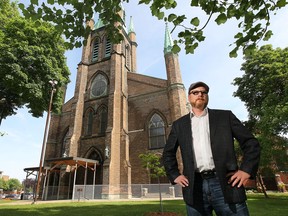 Windsor city councillor Chris Holt, who sits on the city's heritage committee is shown on Tuesday, May 26, 2015, in front of the Assumption Church in Windsor, ON. The church has been named one of the Top 10 endangered places in Canada. (DAN JANISSE/The Windsor Star)