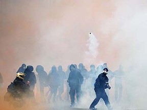 Demonstrators face off against police during a demonstration against Milan's Universal Exposition, EXPO2015, in Milan on May 1, 2015. Italian police clashed with protesters at the Milan Expo on May 1, firing tear gas at the masked demonstrators who had pelted officers with stones. AFP PHOTO / ANDREAS SOLAROANDREAS SOLARO/AFP/Getty Images