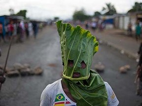 A protester wears a mask made from a leaf in the Cibitoke neighbourhood of Bujumbura on May 5, 2015. Protesters in Burundi dismissed a constitutional court ruling that cleared President Pierre Nkurunziza to run for a controversial third term, as the government offered to release activists if deadly demonstrations stopped. AFP PHOTO / PHIL MOOREPHIL MOORE/AFP/Getty Images
