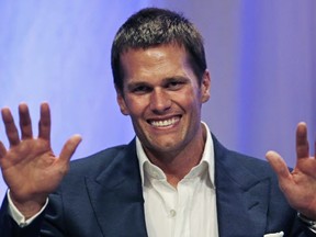 New England Patriots quarterback Tom Brady gestures during an event at Salem State University in Salem, Mass., Thursday, May 7, 2015. An NFL investigation has found that New England Patriots employees likely deflated footballs and that quarterback Tom Brady was "at least generally aware" of the rules violations. The 243-page report released Wednesday, May 6, 2015, said league investigators found no evidence that coach Bill Belichick and team management knew of the practice. (AP Photo/Charles Krupa, Pool)