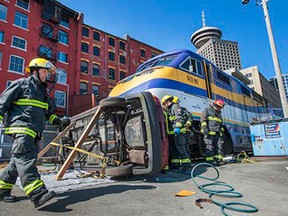 Firefighters participate in mock rescue after a train collided with a car on a railway track in Vancouver, May 19, 2015.