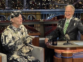 Bill Murray, left, talks with host David Letterman after emerging from a cake to say good-bye, Tuesday, May 19, 2015, on the set of the “Late Show with David Letterman,” in New York. Letterman’s final show airs Wednesday, May 20. (John Paul Filo/CBS via AP)