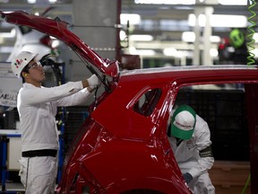 Employees at Honda's assembly plant in Celaya, Mexico. Toyota plans to move production of a small car to Mexico from Ontario. (AP Photo)