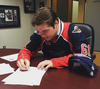 Plymouth’s Luke Boka signs with the Windsor Spitfires Tuesday. (Courtesy of Windsor Spitfires)