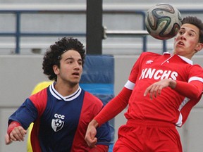 Holy Names' Noah Pio plays the ball off his chest while being defended by Cardinal Carter's James Saba, left, during WECSSAA boys soccer semi-final at Alumni Field, Tuesday, May 12, 2015.  (DAX MELMER/The Windsor Star)