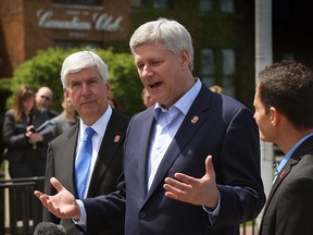Prime Minister Stephen Harper  and Michigan Gov. Rick Snyder, left, and Murray Howe, son of hockey legend Gordie Howe at Hiram Walkers, home of Canadian Club whiskey,  where Harper announced the official name of the new border crossing, Gordie Howe International Bridge, Thursday May 14, 2015. (NICK BRANCACCIO/The Windsor Star)