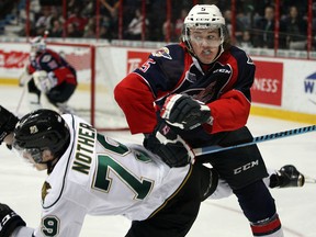 London Knights Tyler Nother, left, is bumped by Windsor Spitfires Nick Gauvin in OHL league action at WFCU Centre Thursday January  29, 2015. (NICK BRANCACCIO/The Windsor Star)