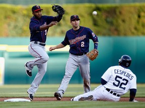 Danny Santana #39 of the Minnesota Twins turns a second inning double play over the sliding Yoenis Cespedes #52 of the Detroit Tigers with teammate Brian Dozier #2 looking on at Comerica Park on May 13, 2015 in Detroit, Michigan.  (Photo by Gregory Shamus/Getty Images)