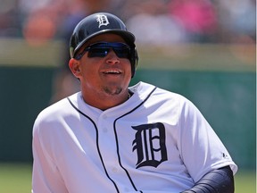Miguel Cabrera #24 of the Detroit Tigers smiles after sliding into third base safe on the single from J.D. Martinez (not in photo) during the first inning of the game against the Minnesota Twins on May 14, 2015 at Comerica Park in Detroit, Michigan. (Photo by Leon Halip/Getty Images)