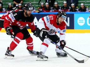 Belle River's Aaron Ekblad, left, checks Austria's Konstantin Komarek earlier this week at the world hockey championships in Prague. (Photo by Martin Rose/Getty Images)