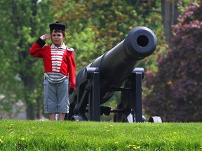 Max D'Alfonso had been waiting for Fort Malden to open for two weeks and he quickly got his chance to dress in period attire and pose beside a cannon for his mother Saturday May 16, 2015.  (NICK BRANCACCIO/The Windsor Star)