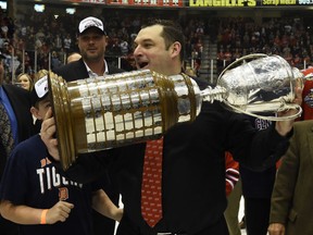Windsor's D.J. Smith holds the OHL championship trophy after Oshawa beat Erie 6-2 Friday. (AARON BELL/OHL Images)