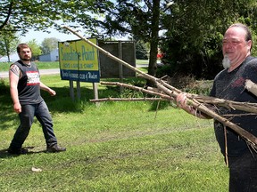Volunteer Chuck Boughner, right, of Bad Examples Riding Club and other volunteers clear away tree trimmings at Kiwanis Sunshine Point boys and girls camp on County Road 50, Sunday, May 17, 2015.   (NICK BRANCACCIO/The Windsor Star)