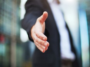 A man extends his hand for a hand shake in this Fotolia photo.