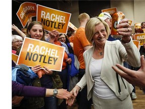 Alberta NDP Leader Rachel Notley holds a can of orange Crush soda pop as she enters a campaign rally in Calgary, Alta., Saturday, May 2, 2015.