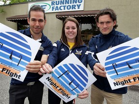 Pole vault athletes Jennifer Tomayer, centre, and Milos Savic and pole vaulting coach Kevin DiNardo, left, promote Night Flight, an outdoor pole vault competition scheduled for Ouellette Avenue. Athletes with University of Windsor Althletics Club were joined by coaches and track and field volunteers during a press conference at Running Factory May 19, 2015. (NICK BRANCACCIO/The Windsor Star).