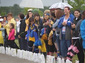 Spectators look on at the Vollmer Complex in LaSalle, Ont. during the Relay for Life event that features dozens of survivors and over 70 corporate teams. (DAN JANISSE/The Windsor Star)