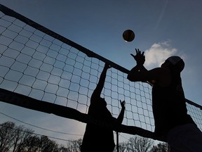 Josh Rankin and Julian Miletic play volleyball late in the afternoon during the San Dune Beach Volleyball league in Windsor, Ontario on May 6, 2015. (JASON KRYK/The Windsor Star)