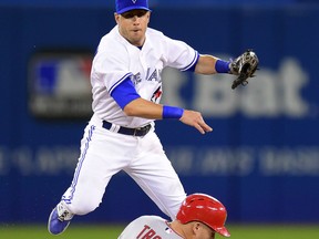 Toronto Blue Jays' Steve Tolleson throws to first for the double play as Los Angeles Angels' Mike Trout is forced out at second during sixth inning American League baseball action in Toronto, Tuesday, May 19, 2015. Angels' Albert Pujols hit into the play. THE CANADIAN PRESS/Frank Gunn