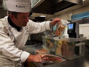 Chef Marc Johnston works with sous-vide appliances at St. Clair College Friday May 22, 2015.  Chef Johnston is co-ordinator of culinary management program at St. Clair College. (NICK BRANCACCIO/The Windsor Star)