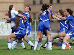 St. Anne Saints girls soccer team celebrate their shootout victory over Holy Names on May 20, 2015. (JASON KRYK/The Windsor Star)