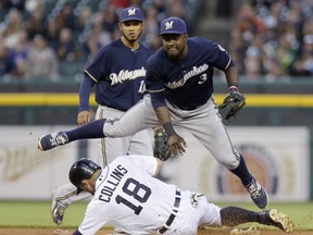 Second baseman Elian Herrera #3 of the Milwaukee Brewers avoids Tyler Collins #18 of the Detroit Tigers after turning the ball in an attempt to get a double play as shortstop Luis Sardinas #10 of the Milwaukee Brewers looks on during the fourth inning at Comerica Park on May 20, 2015 in Detroit, Michigan. Nick Castellanos of the Detroit Tigers hit into the play but was safe at first base. (Photo by Duane Burleson/Getty Images)