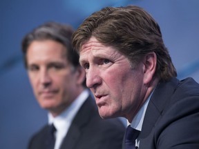 Toronto Maple Leafs new head coach Mike Babcock, right, speaks to reporters with president Brendan Shanahan during a press conference in Toronto on Thursday, May 21, 2015. THE CANADIAN PRESS/Darren Calabrese