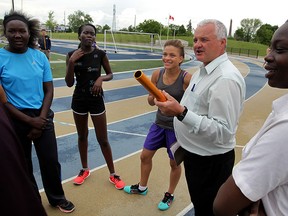 The local running community lost a cornerstone with the sudden passing of Gary Malloy, who is seen at the centre of this photo coaching athletes from Assumption high school.