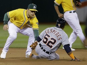 Detroit Tigers' Yoenis Cespedes (52) is tagged out trying to steal second base by Oakland Athletics second baseman Ben Zobrist during the seventh inning of a baseball game in Oakland, Calif., Tuesday, May 26, 2015. (AP Photo/Jeff Chiu)