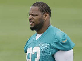 Miami Dolphins defensive tackle Ndamukong Suh looks on during an NFL football organized team activity, Tuesday, May 26, 2015, at the Dolphins training facility in Davie, Fla. (AP Photo/Wilfredo Lee)